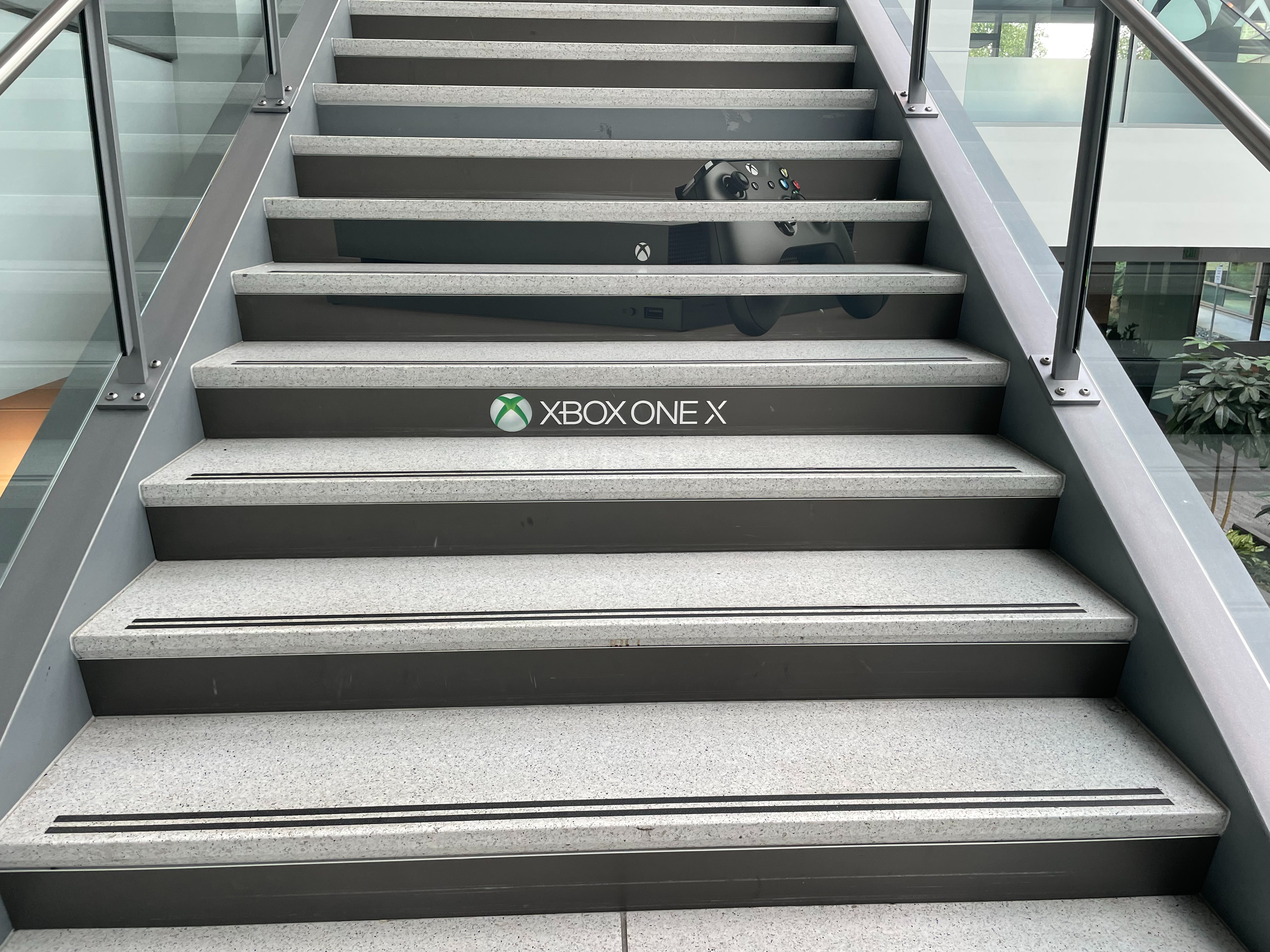 Image of stairs in Studio D at xbox with a wrap depicting their logo and a controller